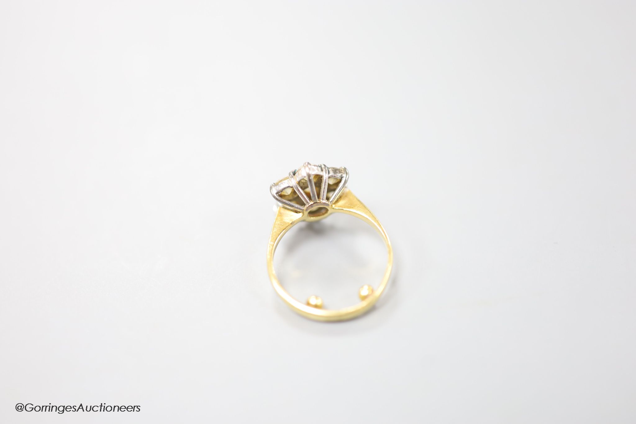 A modern 18ct gold and seven stone diamond cluster ring, size E (sizing spheres), gross weight 3.7 grams.